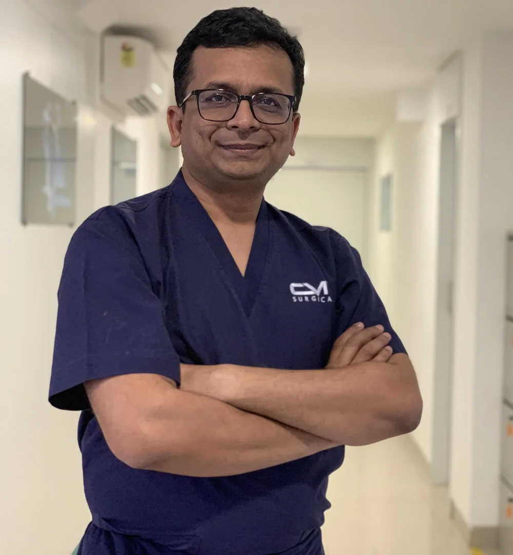 Dr. Arvind Patel in surgical scrubs at Kiran Hospital, Surat
