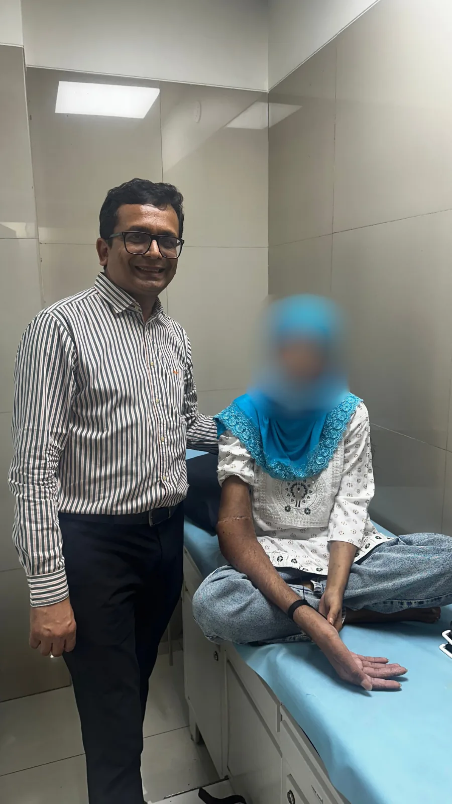 A hand transplant recipient at follow up with Dr. Arvind Patel at Kiran Hospital, Surat